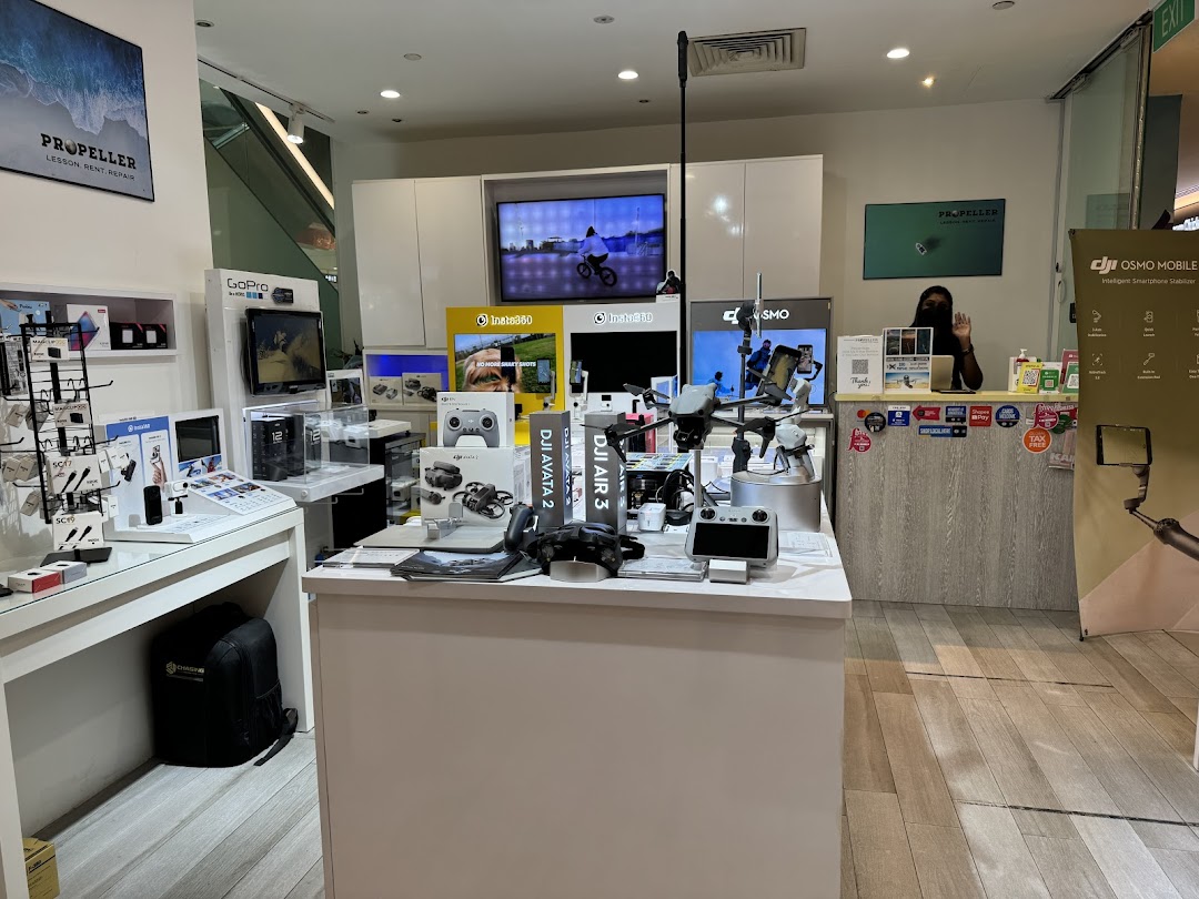 Interior view of Propeller Singapore, a tech shop featuring DJI drones, GoPro, Insta360 cameras, and accessories.