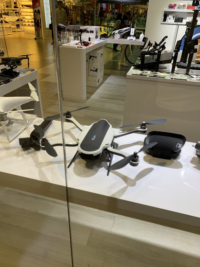 A retail display showcasing various drones, camera equipment, and accessories inside Propeller Singapore.