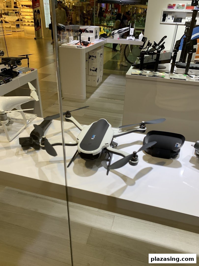 A retail display showcasing various drones, camera equipment, and accessories inside Propeller Singapore.