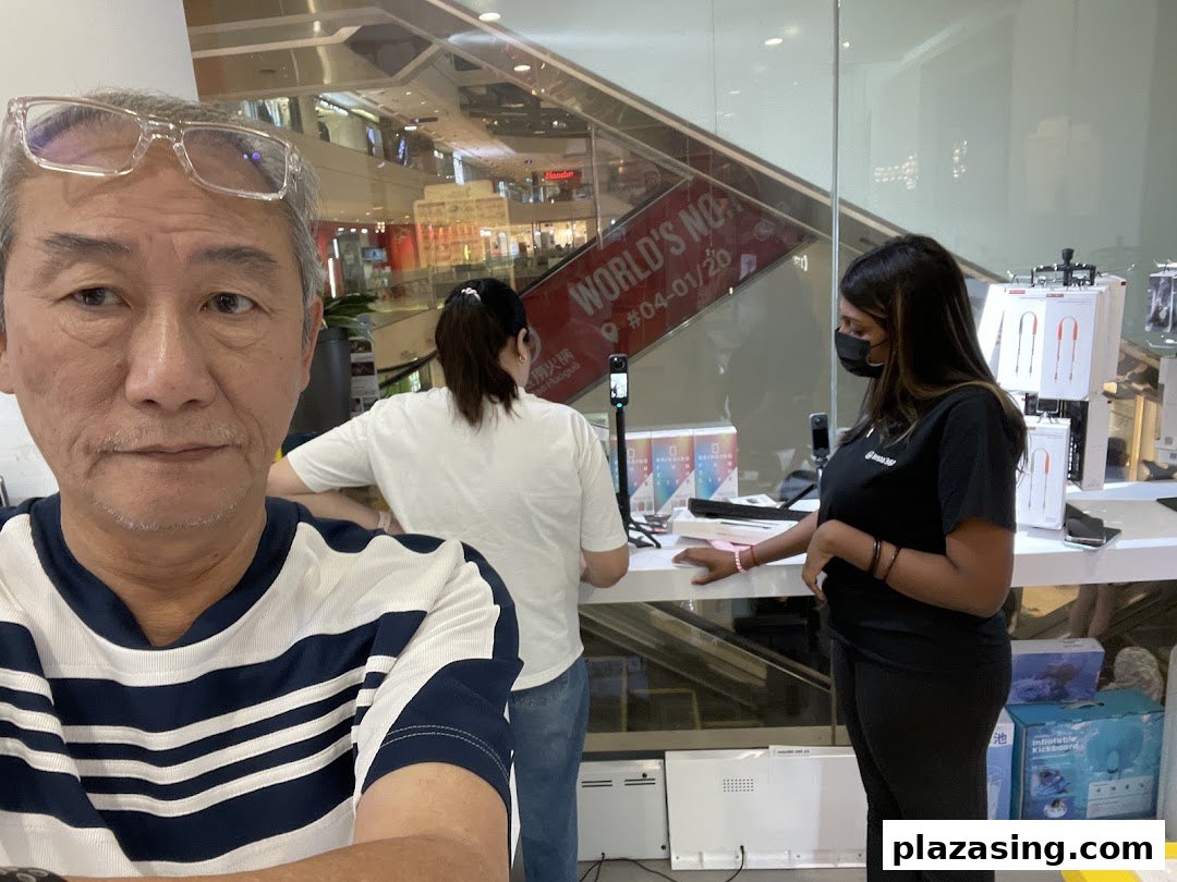 A customer's selfie inside Propeller Singapore, showcasing staff and various tech products on display.