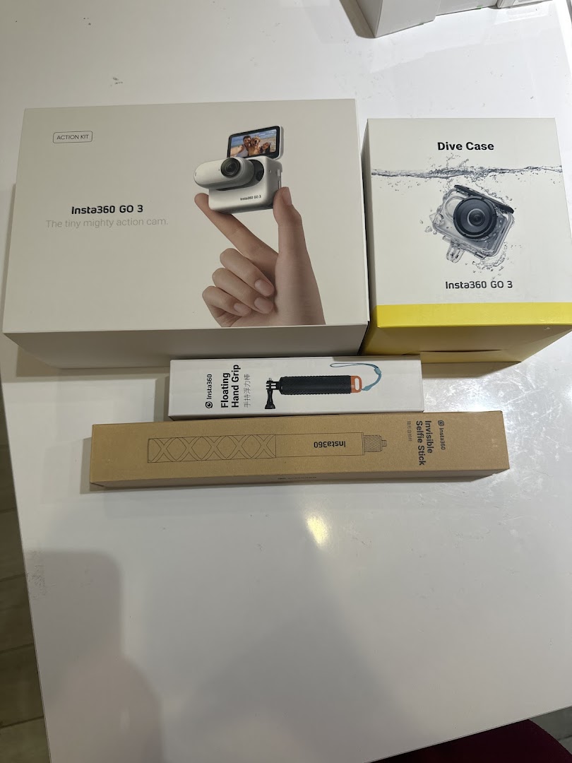 Boxes of Insta360 GO 3 action camera, dive case, floating hand grip, and invisible selfie stick.