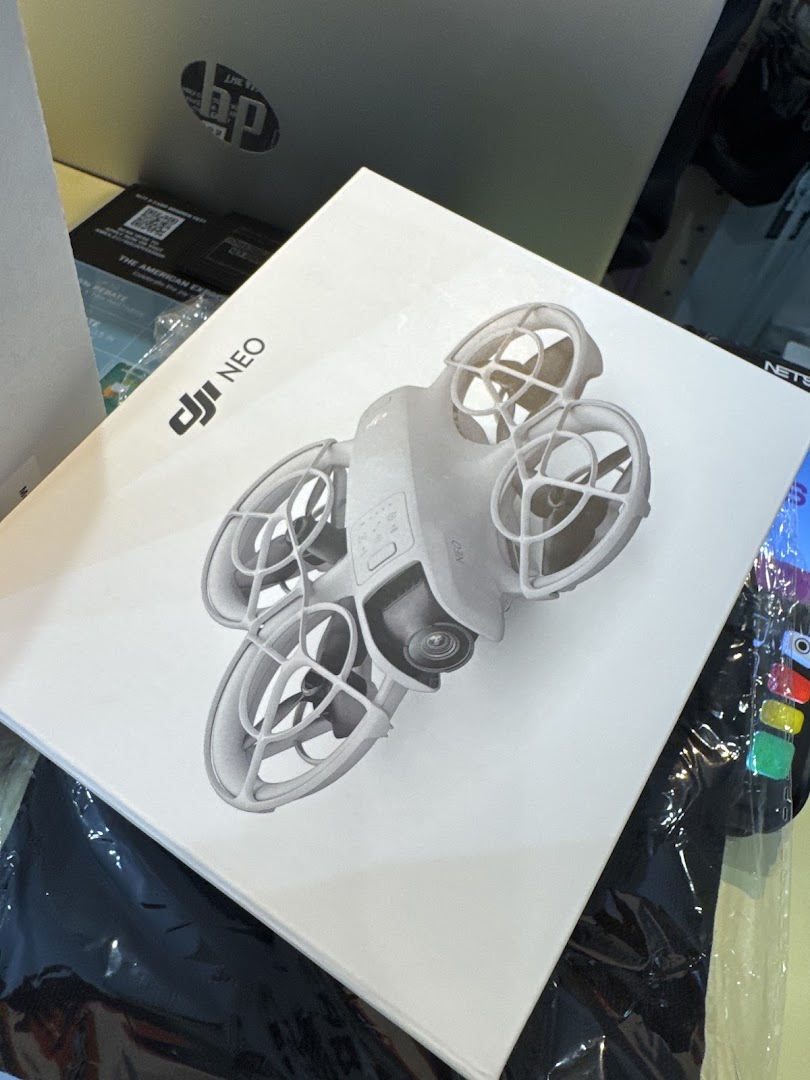 Close-up of a white product box featuring a DJI NEO drone, likely from a tech or gadget store.