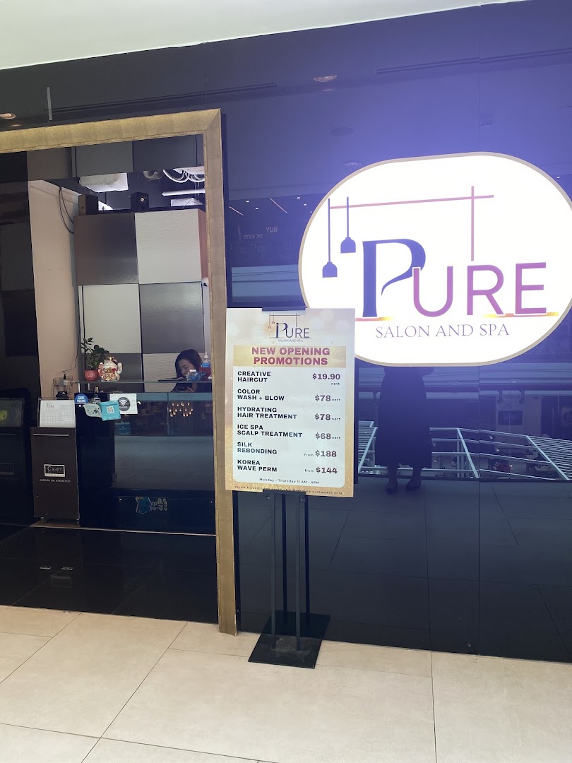 A promotional sign for Pure Salon and Spa's new opening offers, visible at the shop entrance.