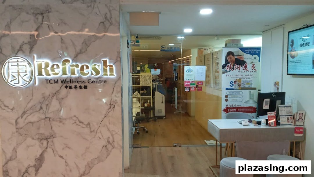 The entrance of Refresh TCM Wellness Centre, featuring a reception desk and promotional displays.
