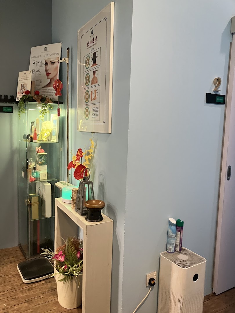 A serene corner of Refresh TCM Wellness, featuring a product display, treatment poster, and wellness amenities.