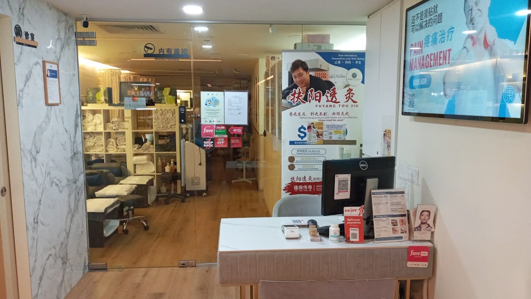 Entrance of Refresh TCM Wellness, featuring a reception desk, promotional banners, and a glimpse into treatment rooms.