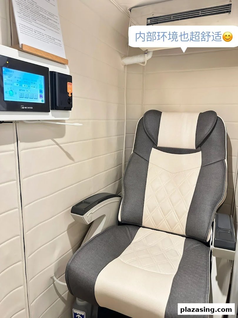 A comfortable reclining chair and control panel inside a private wellness booth.