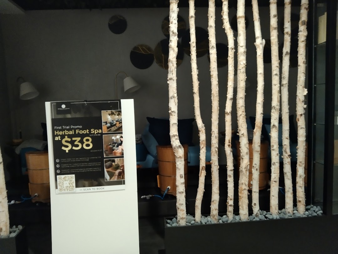 Interior view of Refresh TCM Wellness, featuring a serene foot spa area and a promotional sign.