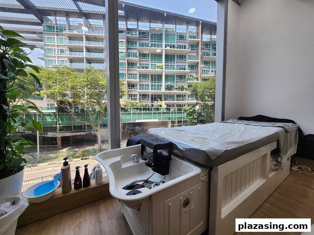 A serene treatment room at Refresh TCM Wellness with a bed and basin, offering city views.