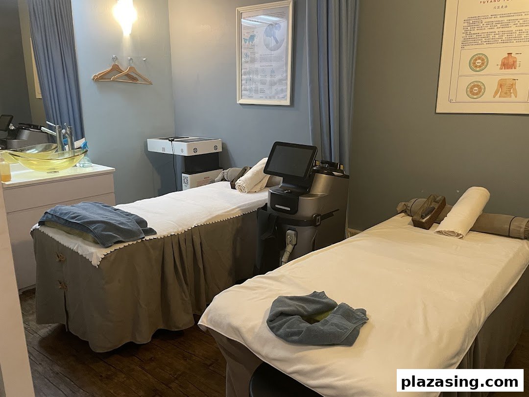 A tranquil wellness room featuring two treatment beds, modern equipment, and a soothing ambiance.