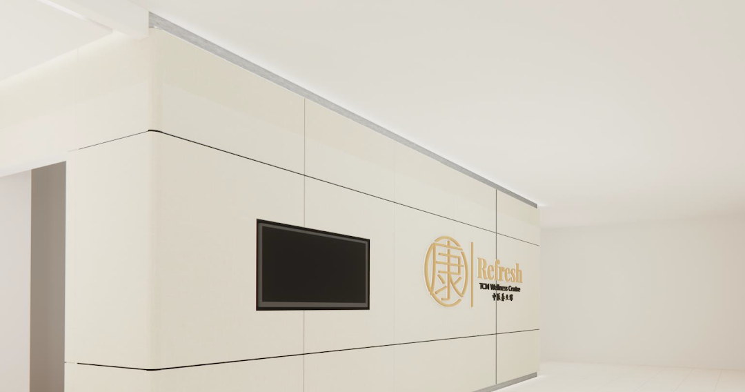 The image displays the clean, modern entrance of Refresh TCM Wellness with its golden logo and signage.
