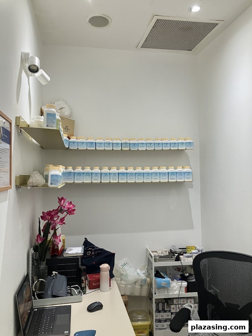 Interior view of a Refresh TCM Wellness consultation room with product shelves and a desk.