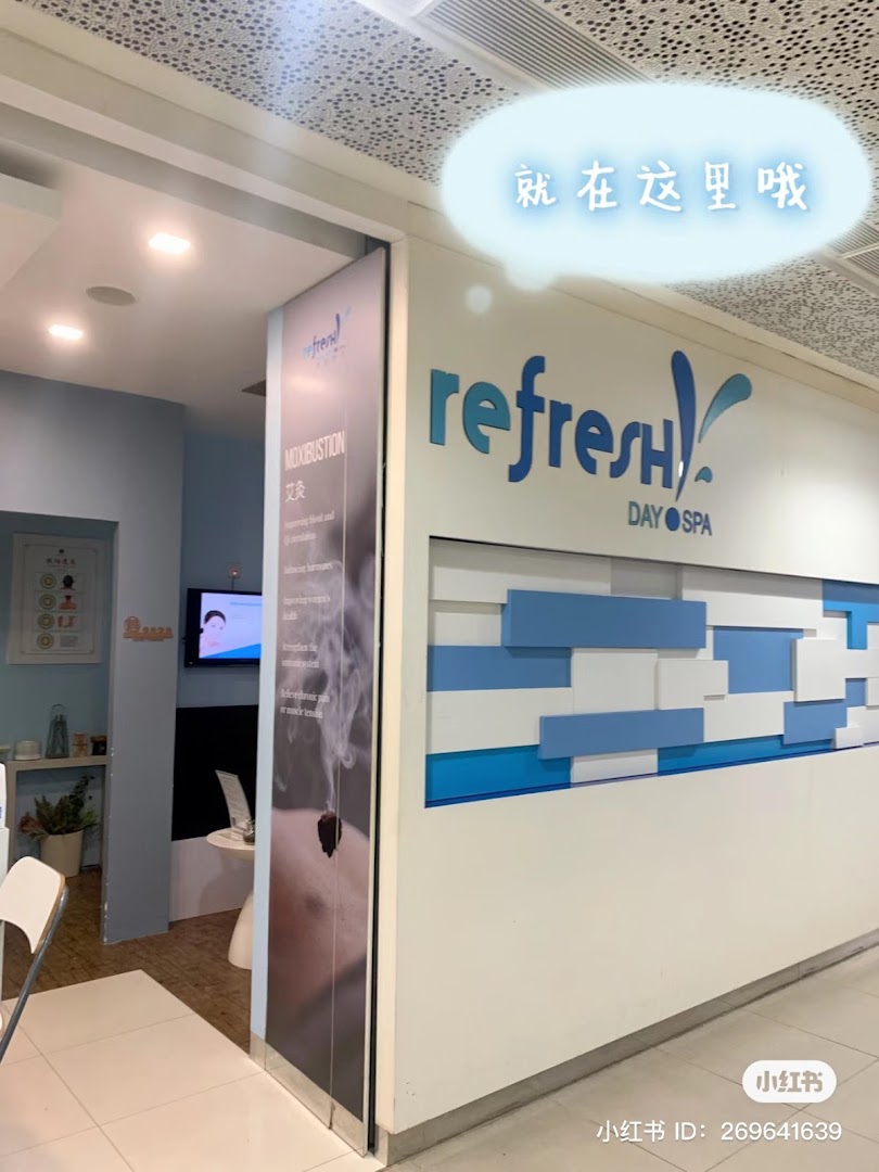 The inviting entrance of Refresh Day Spa, featuring blue and white decor and a moxibustion display.