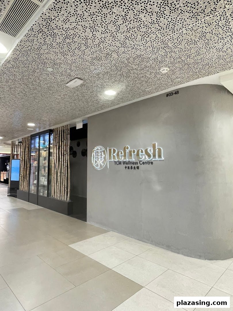 The shop front of Refresh TCM Wellness Centre, featuring its illuminated logo and display windows.