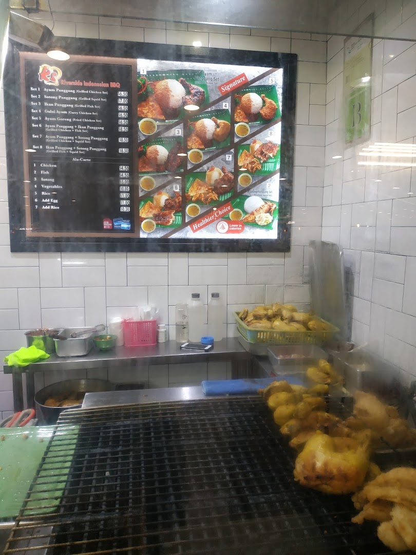 A menu board for Riverside Indonesian BBQ, showcasing various grilled and fried dishes with prices.