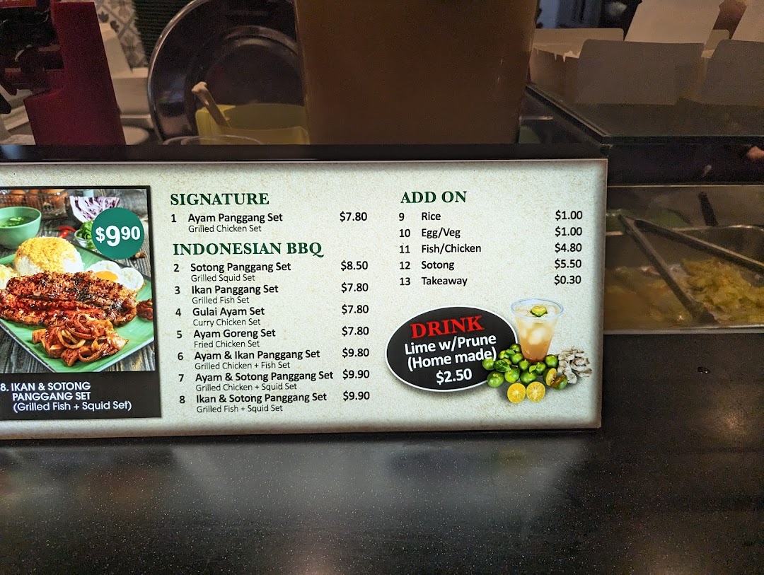 A detailed menu board displaying Indonesian BBQ sets, add-ons, and a homemade drink.