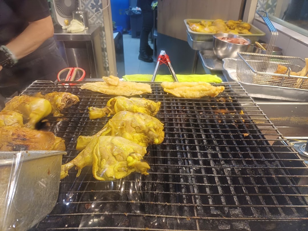 Close-up of marinated chicken and other items grilling on a barbecue at Riverside Indonesian BBQ.