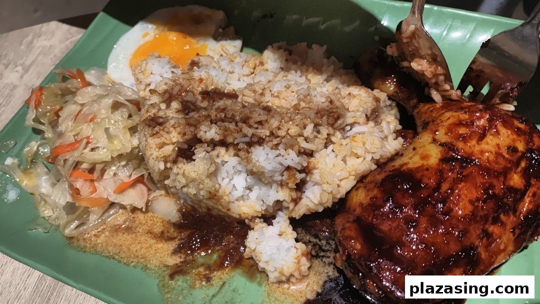 A delicious plate of Indonesian BBQ chicken with rice, a fried egg, and pickled vegetables.
