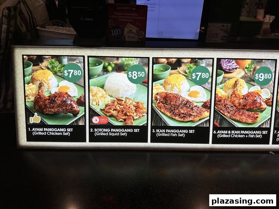 A brightly lit menu board displaying various Indonesian grilled food sets with prices.