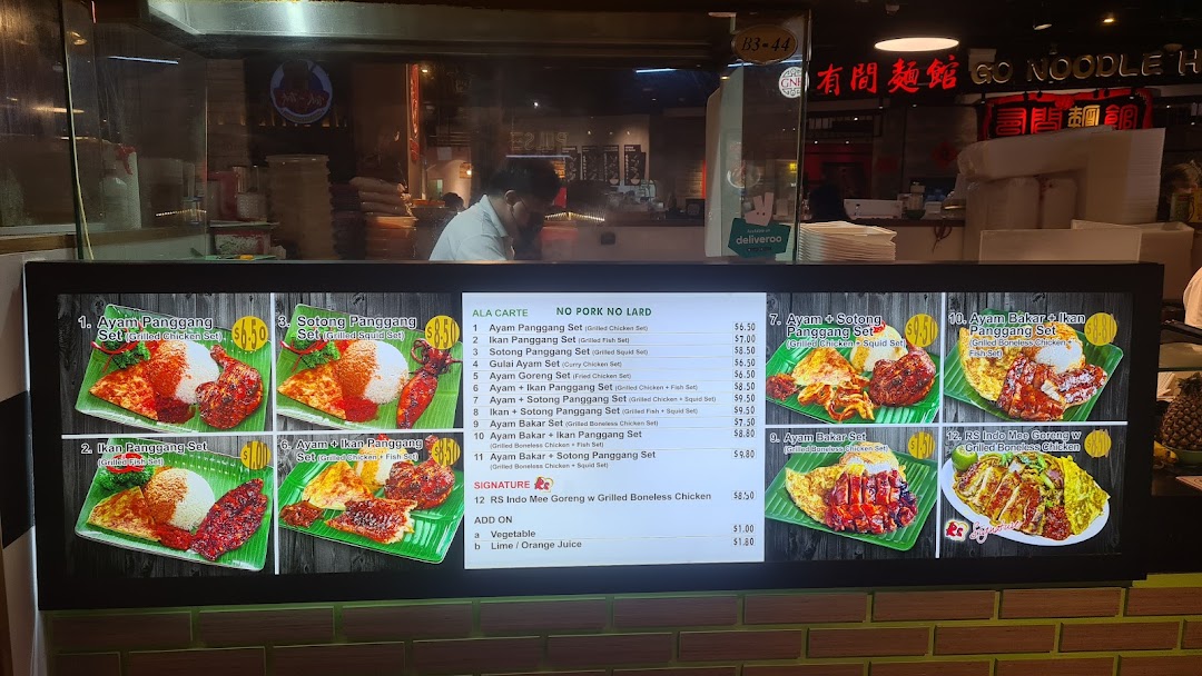 A digital menu board displaying various Indonesian BBQ sets and add-ons with prices.