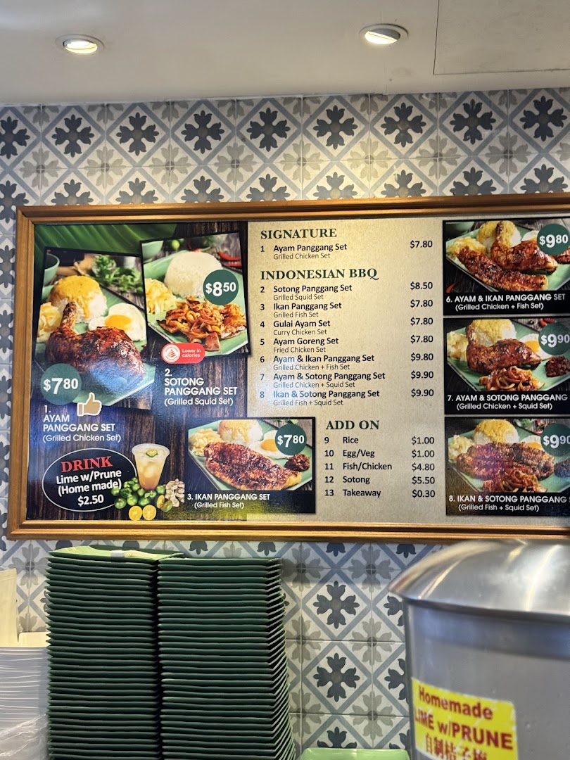 A vibrant menu board displaying various Indonesian BBQ sets, drinks, and add-ons with prices.