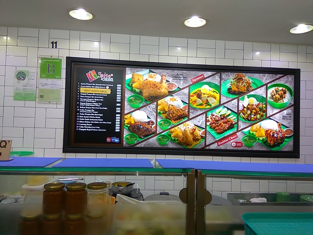 A vibrant digital menu board showcasing various Indonesian dishes with images and item names.