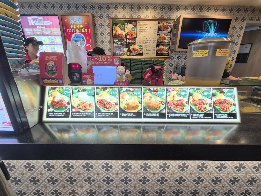 A food stall counter displaying various Indonesian BBQ dishes and menu items with prices.