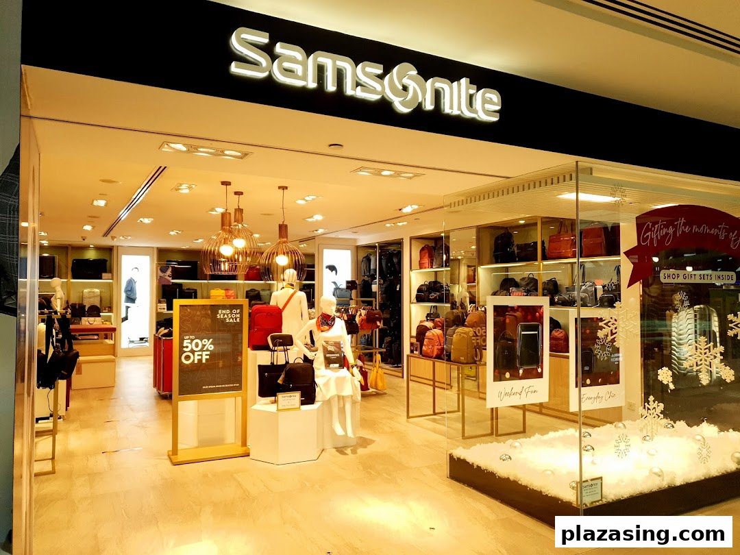 The Samsonite shop front displays luggage, bags, and a 'Up to 50% Off' sale sign, with festive window decorations.