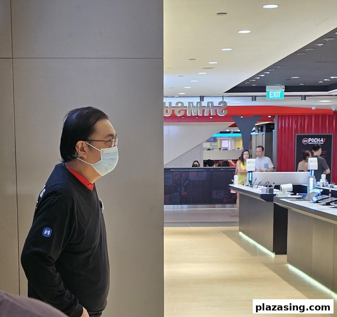 Interior view of a Samsung Service Centre with staff and product displays.