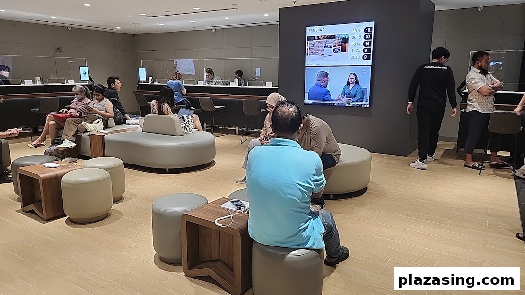 Customers wait and staff assist in a modern Samsung Service Centre with comfortable seating.