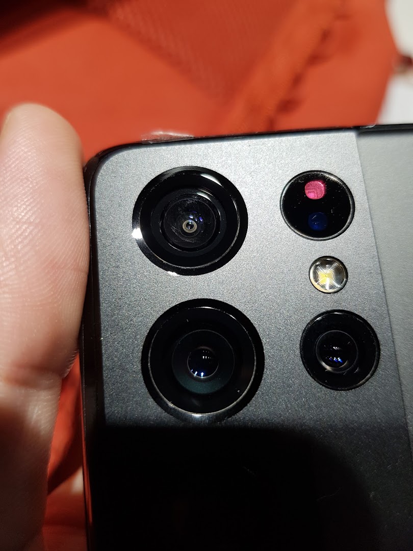 Close-up view of a Samsung smartphone's multi-lens camera system and flash.