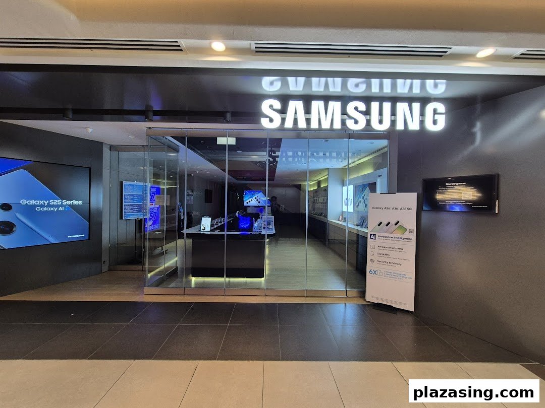 Exterior view of a Samsung Service Centre with illuminated signage and promotional displays for Galaxy devices.