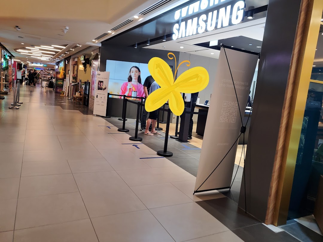 The entrance of a Samsung Service Centre in a mall, featuring a digital display and queue management.