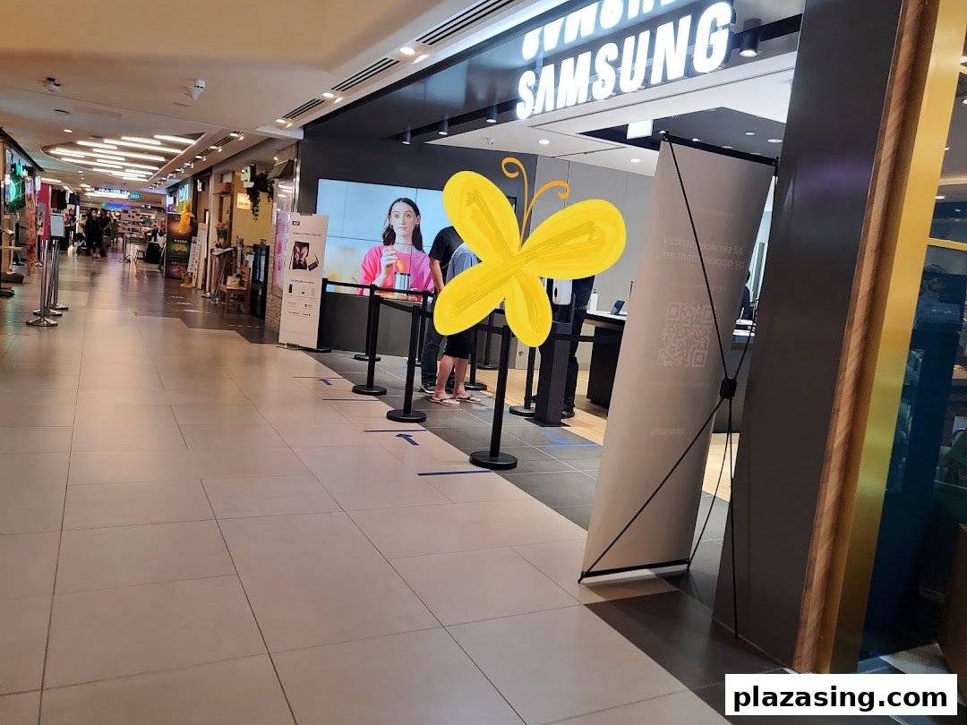 The entrance of a Samsung Service Centre in a mall, featuring a digital display and queue management.