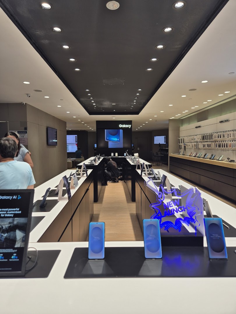 Interior view of a modern Samsung store showcasing various Galaxy devices and accessories on display.