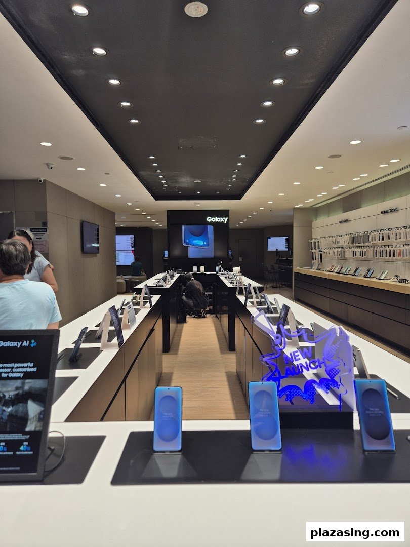 Interior view of a modern Samsung store showcasing various Galaxy devices and accessories on display.
