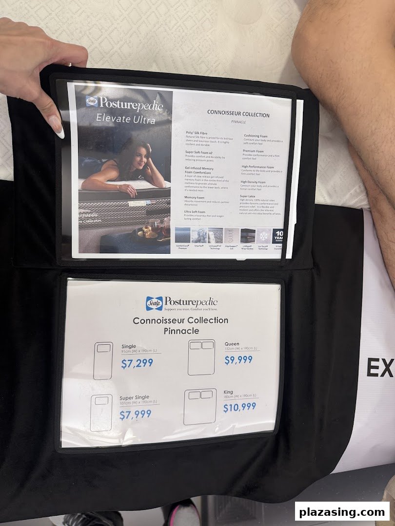 A close-up of Sealy Posturepedic mattress product information and pricing displayed in a showroom.