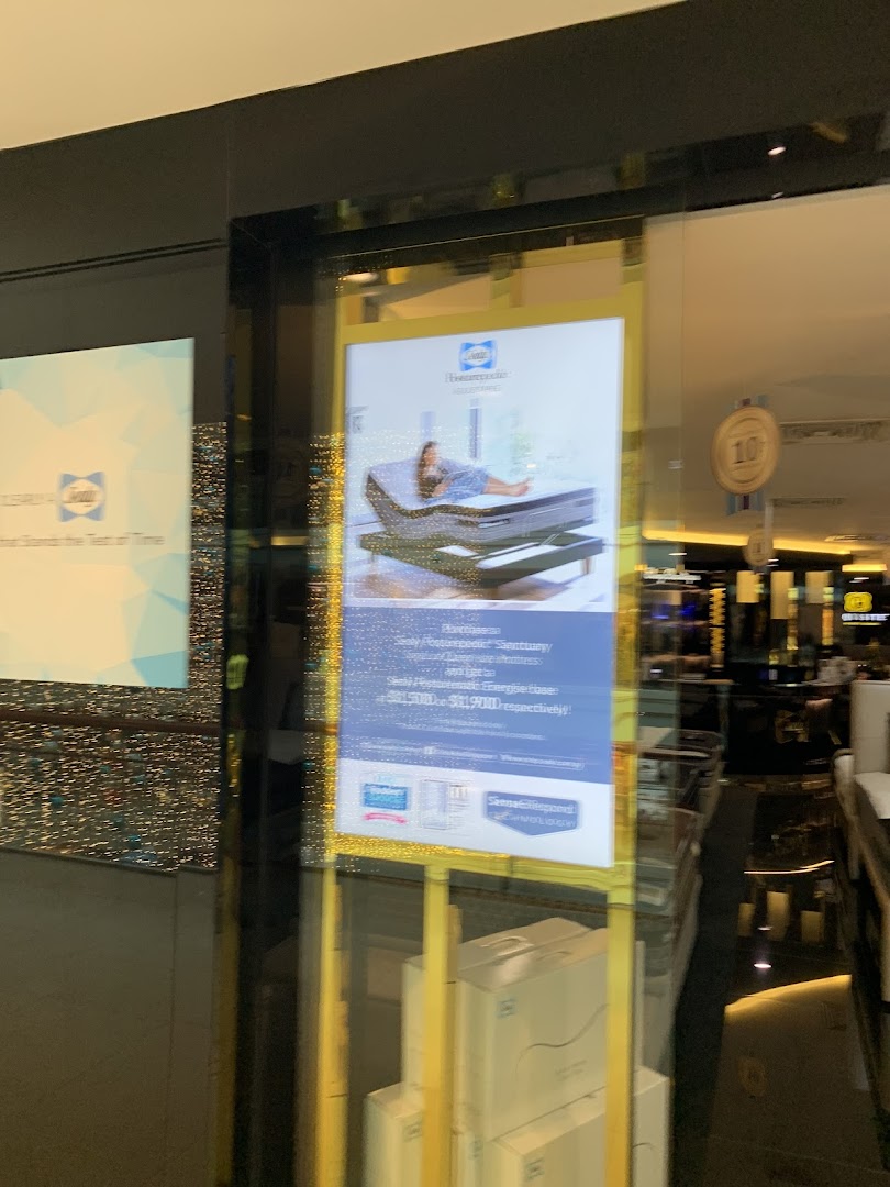 The exterior of Sealy Sleep Boutique, showcasing a promotional display with a mattress and adjustable base.