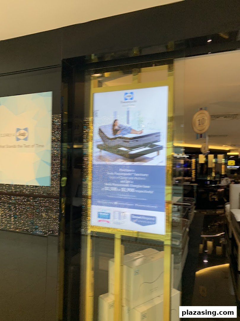 The exterior of Sealy Sleep Boutique, showcasing a promotional display with a mattress and adjustable base.