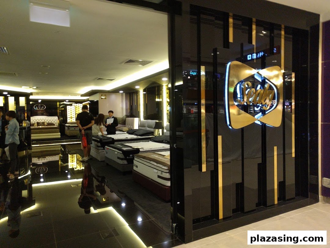 The Sealy Sleep Boutique entrance features a prominent gold logo, inviting customers into a showroom displaying various mattresses.