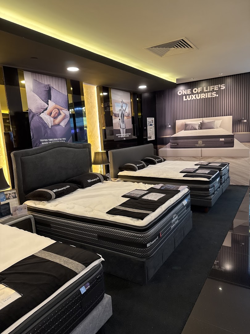 Interior view of Sealy Sleep Boutique showcasing multiple luxurious mattresses and beds on display.