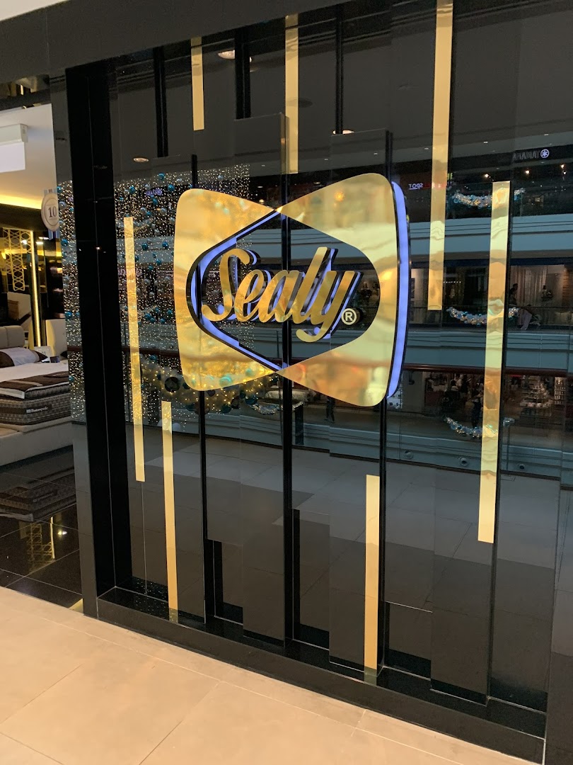 The Sealy Sleep Boutique shop front features a prominent gold Sealy logo on a sleek glass entrance.