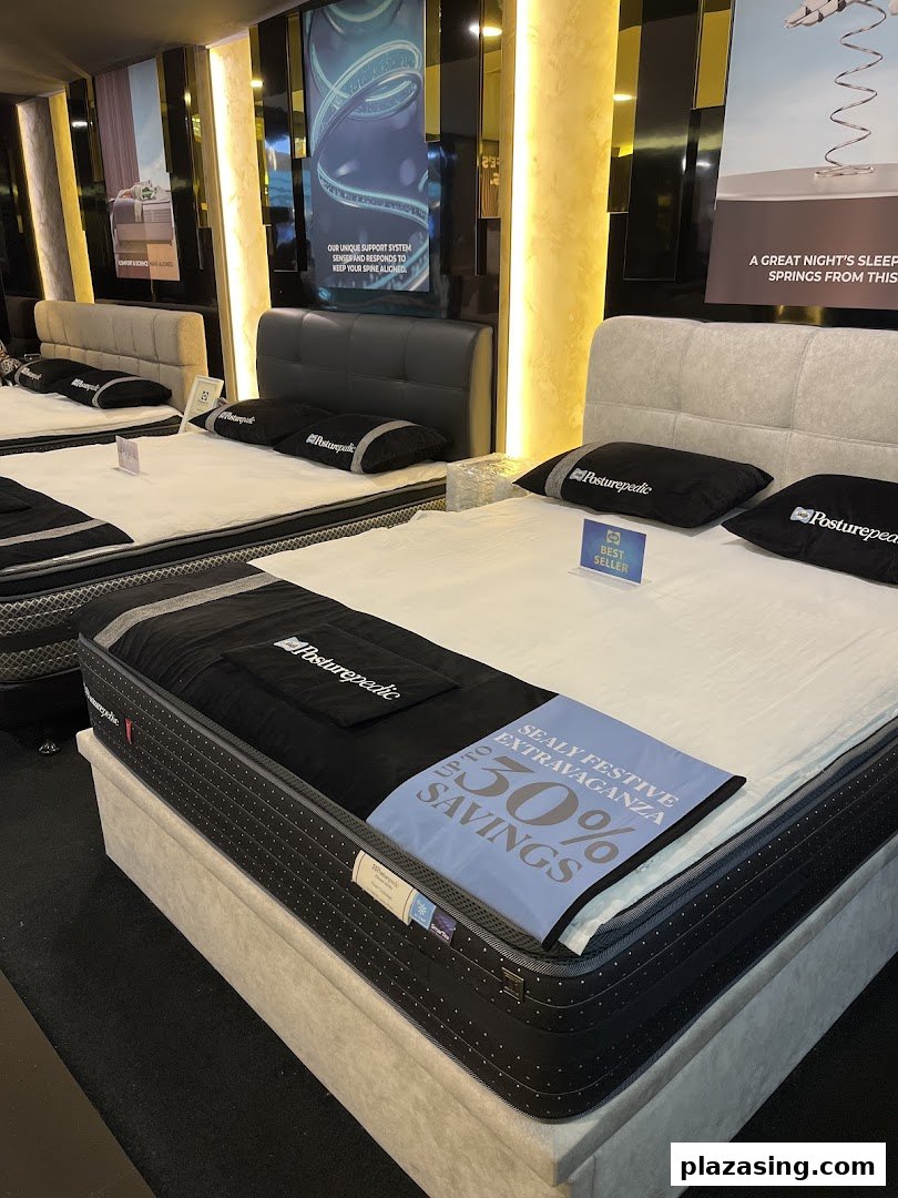An interior view of Sealy Sleep Boutique showcasing various Posturepedic mattresses and beds on display.
