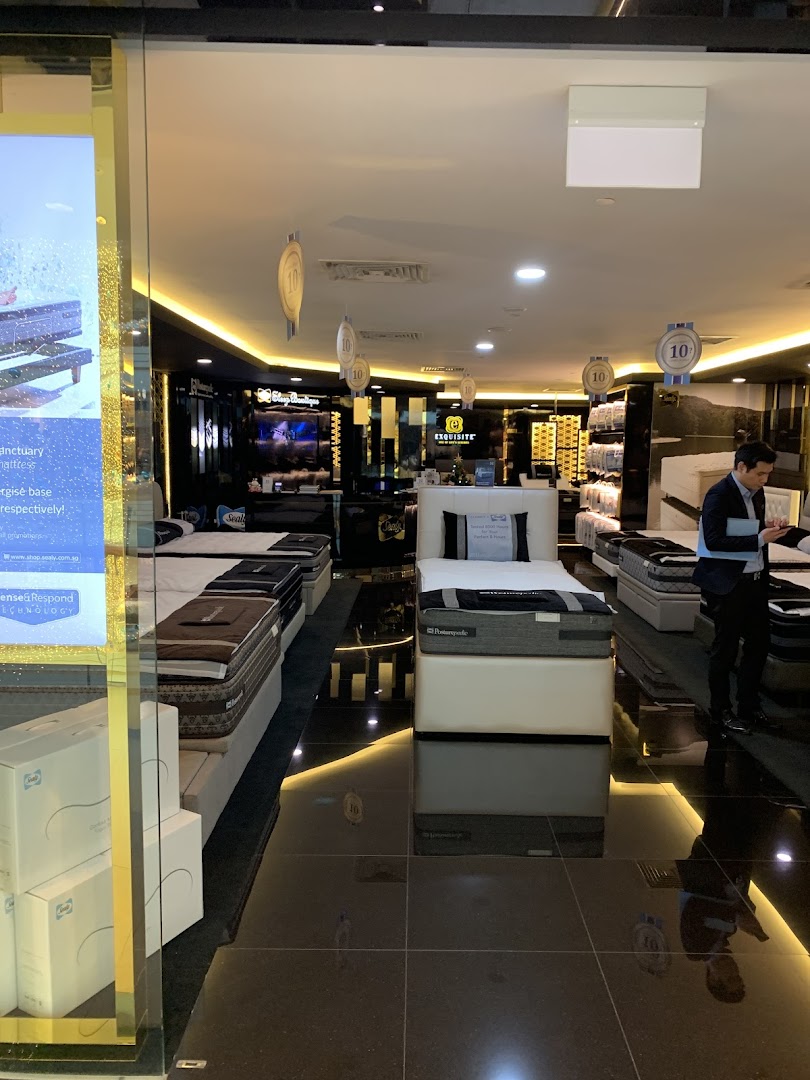 An interior view of Sealy Sleep Boutique showcasing various mattresses and bedding displays.