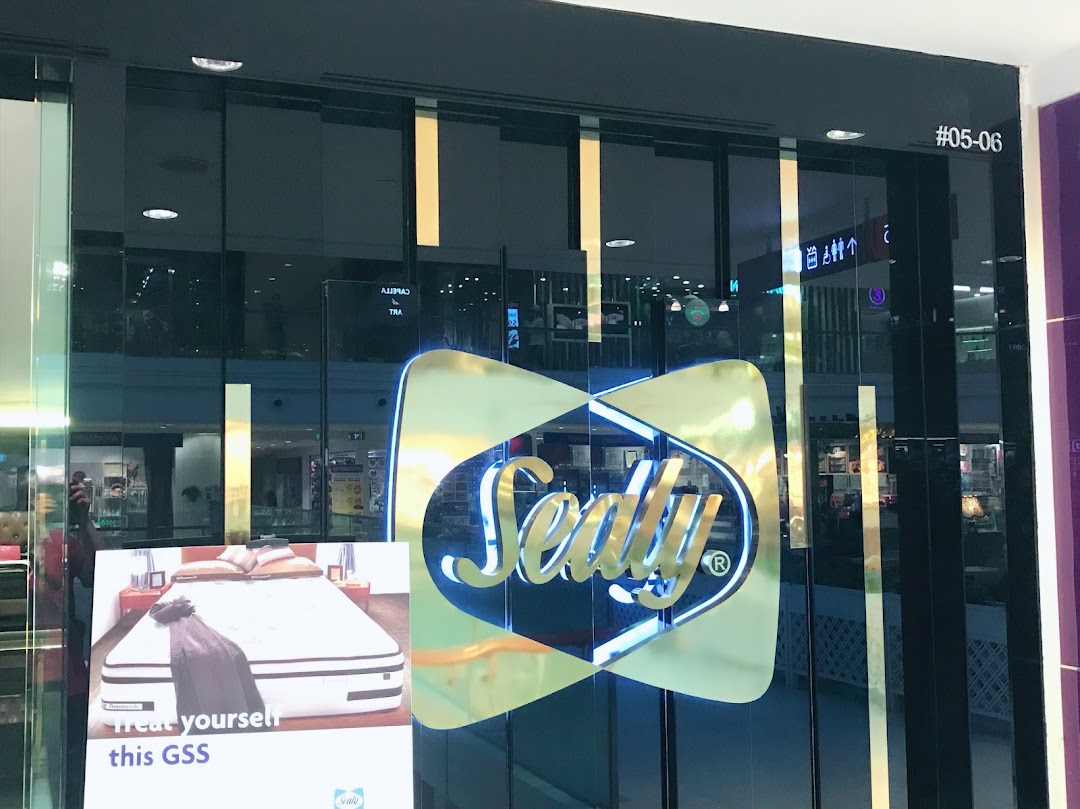 The entrance of Sealy Sleep Boutique with its prominent logo and a promotional sign for mattresses.