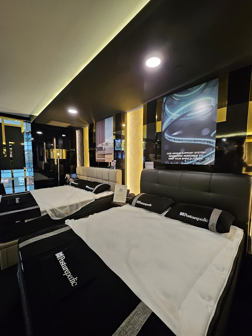 An interior view of Sealy Sleep Boutique showcasing multiple Posturepedic mattresses and beds in a modern showroom.