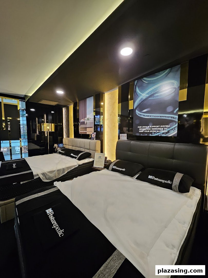 An interior view of Sealy Sleep Boutique showcasing multiple Posturepedic mattresses and beds in a modern showroom.