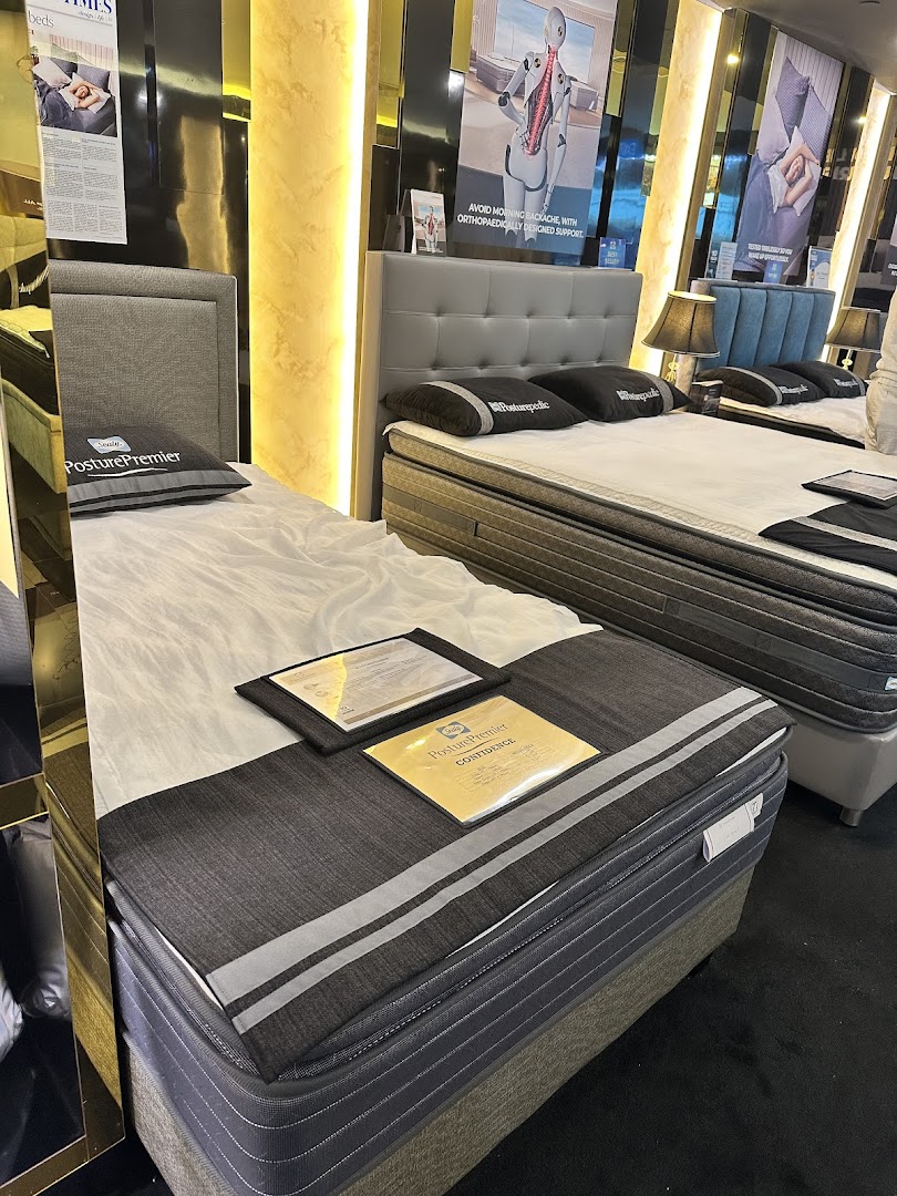 Showroom display of Sealy mattresses and beds, highlighting orthopedic support and comfort.