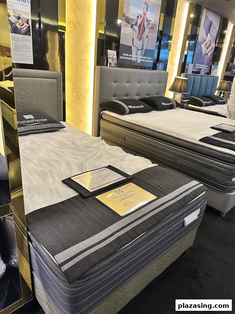 Showroom display of Sealy mattresses and beds, highlighting orthopedic support and comfort.