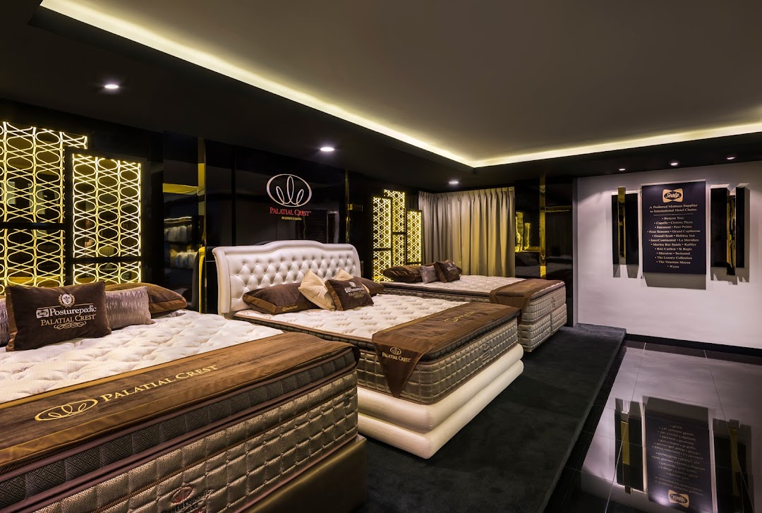 Interior view of a luxurious mattress showroom featuring multiple beds and elegant decor.